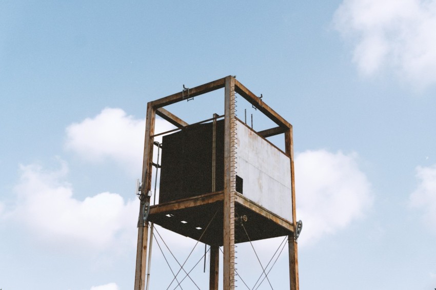 brown and white metal tank under blue sky during daytime