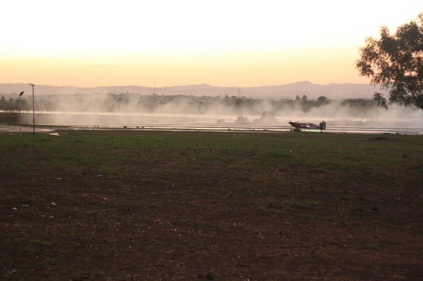 a boat on a body of water with steam rising from it