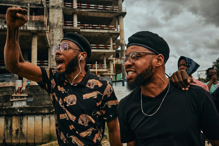man in black and brown floral button up shirt wearing black cap qNY4I pep