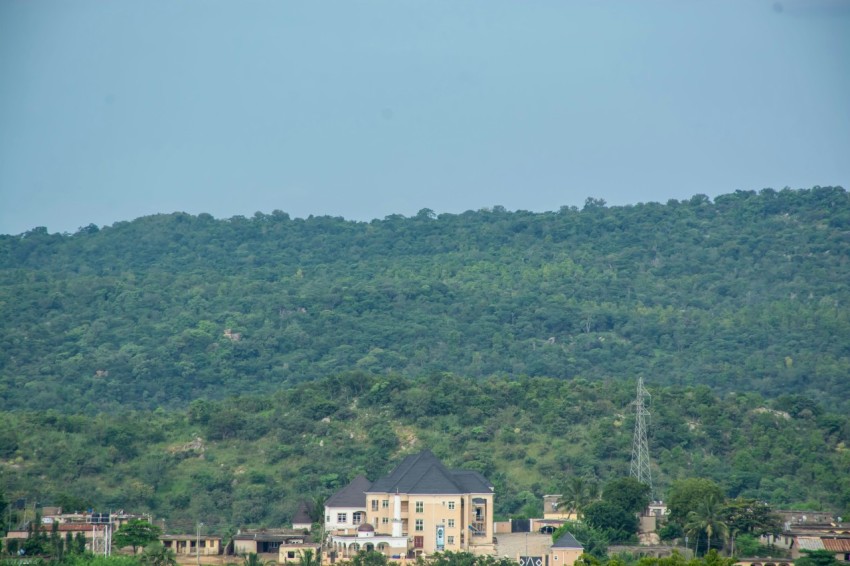 a large building sitting on top of a lush green hillside