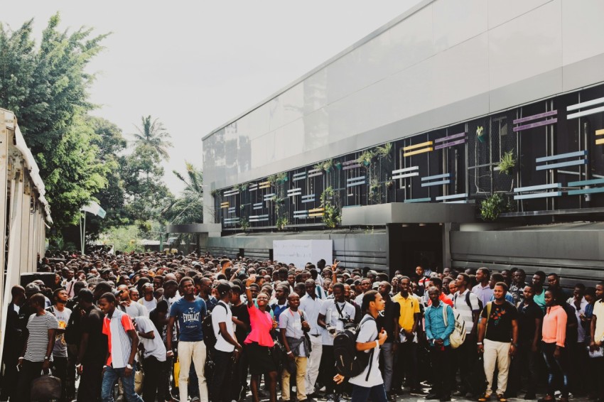 a large group of people standing in front of a building