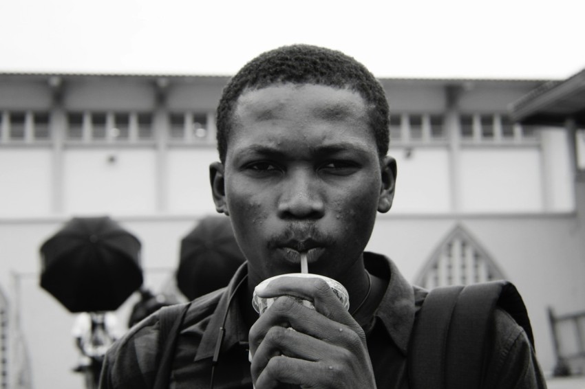 grayscale photography of man sipping on straw ruTDZVWx