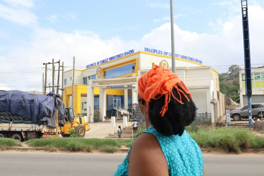 a woman walking down the street in front of a building