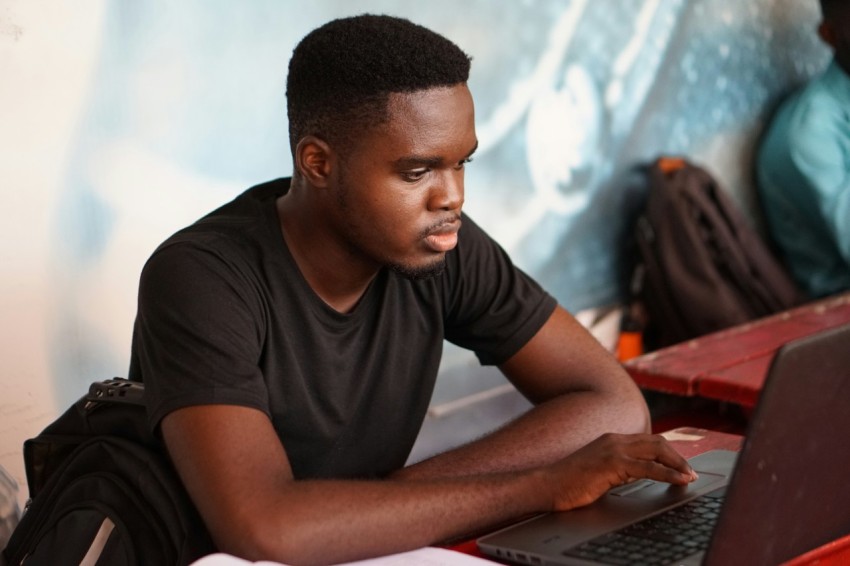 man in gray crew neck t shirt using laptop computer