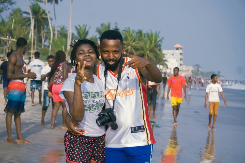 man in white and orange crew neck t shirt standing beside woman in white t shirt