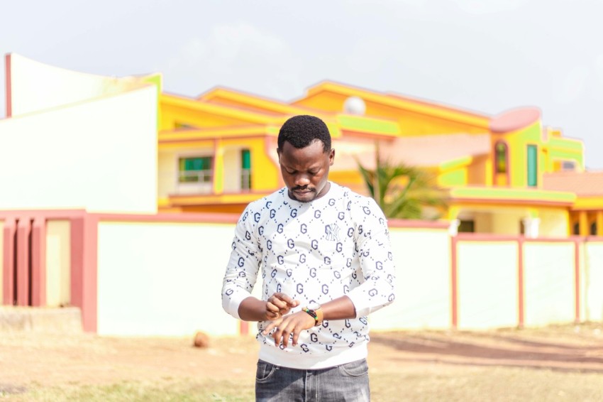 man in white and black button up shirt standing during daytime