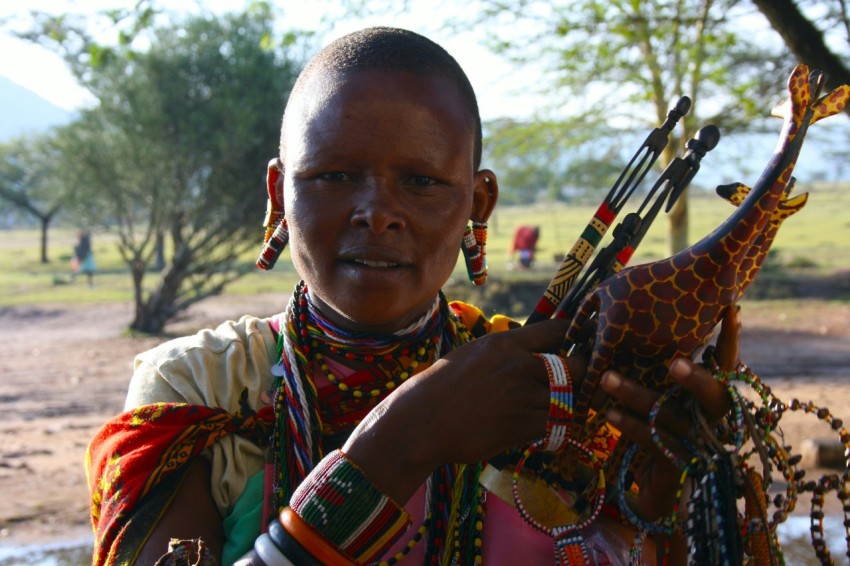 a woman holding a giraffe shaped object in her hands