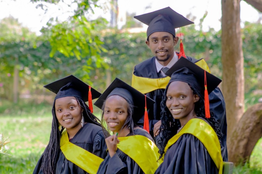 a group of people in graduation gowns posing for a picture J2jdh2Wiw