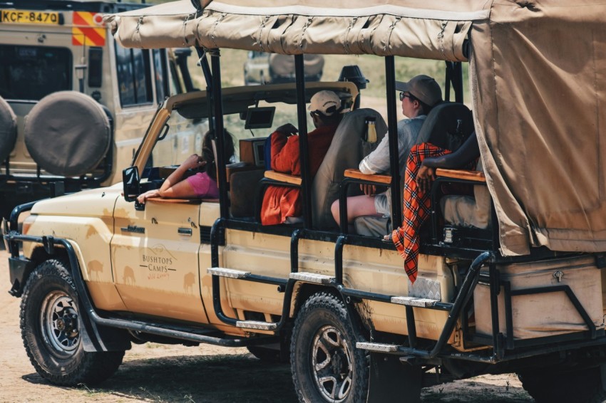 a group of people riding in the back of a truck Soa9a8