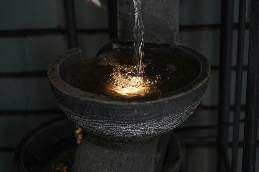 a close up of a fountain with water pouring from it