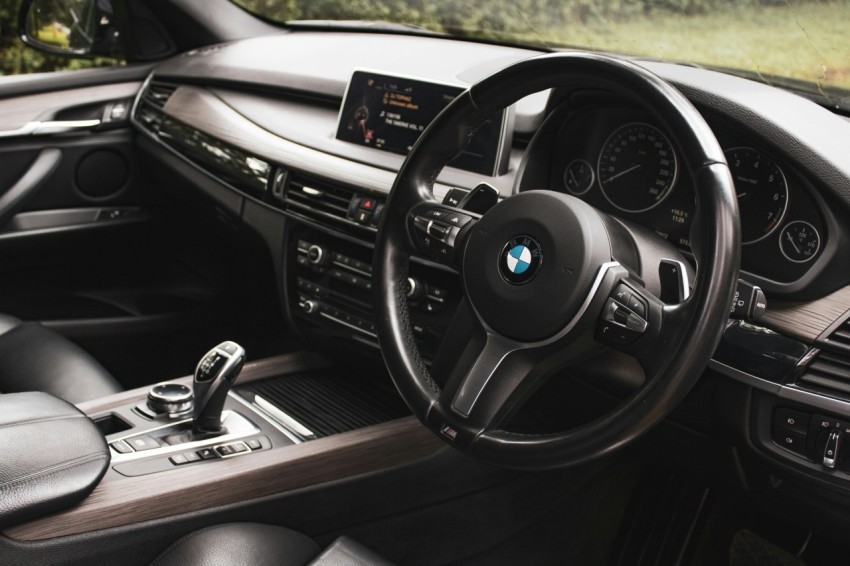 the interior of a car with a steering wheel and dashboard