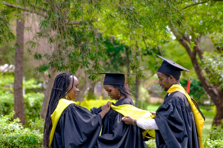 a group of people standing next to each other in graduation gowns