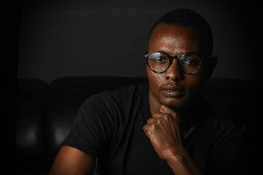 shallow focus photo of man wearing eyeglasses with black frames