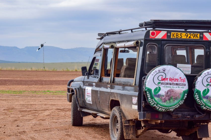 a vehicle parked on a dirt road in the middle of nowhere