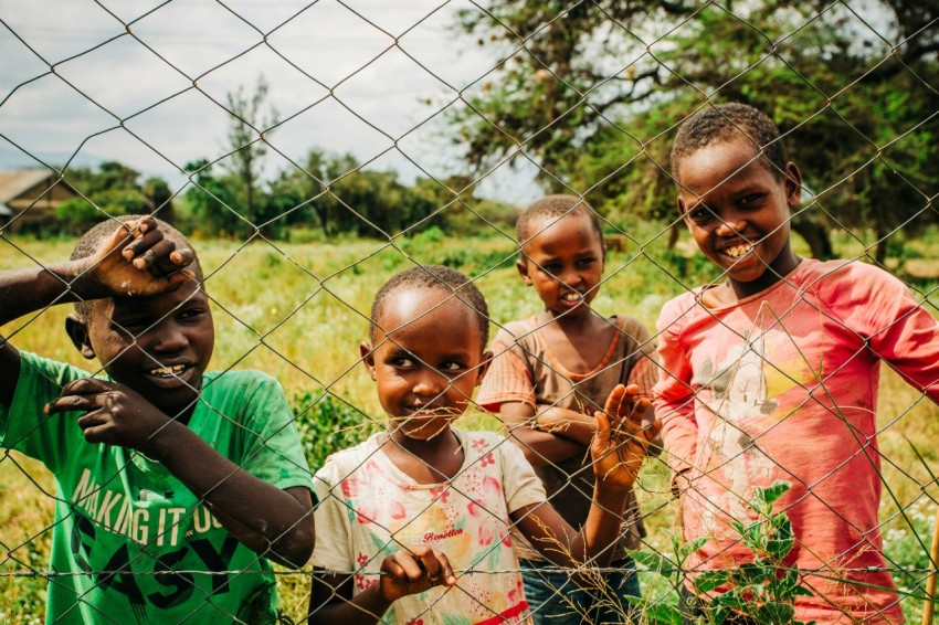 selective focus photography of children standing near trees