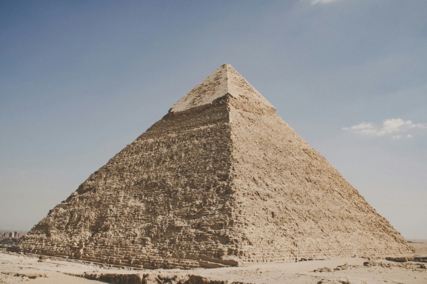 pyramid on brown sand under blue sky during daytime