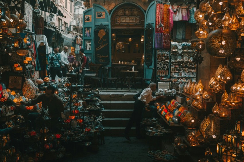 a group of people sitting in a room with lots of colorful objects