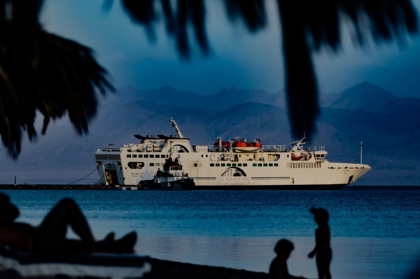 a large white boat sitting on top of a body of water yb3