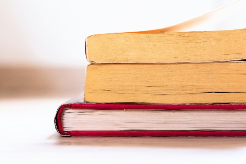 a stack of books sitting on top of each other PGckW3N7