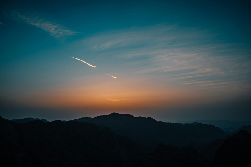 silhouette of mountains under blue sky during sunset