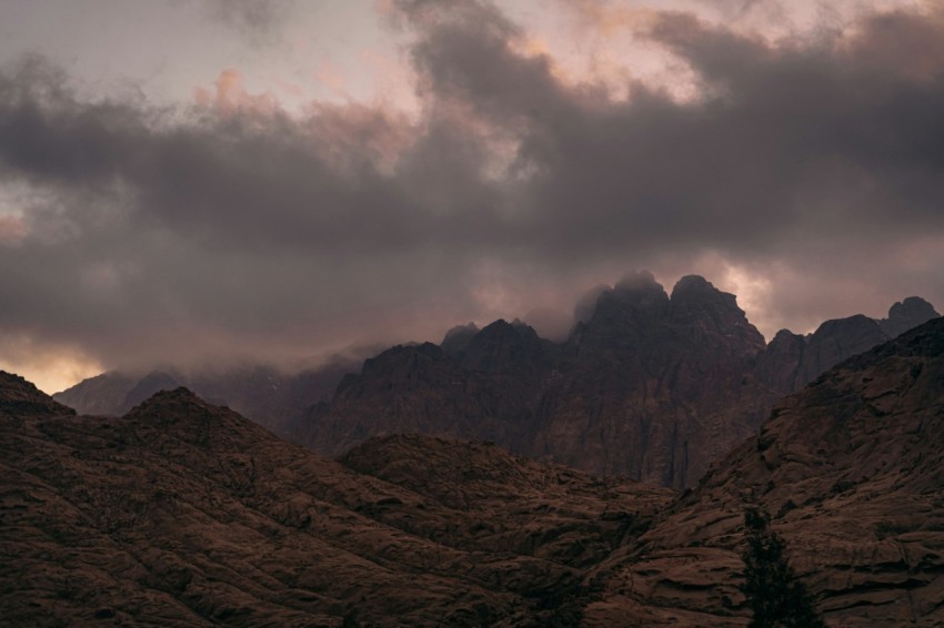 brown rocky mountain under cloudy sky during daytime UGX0M