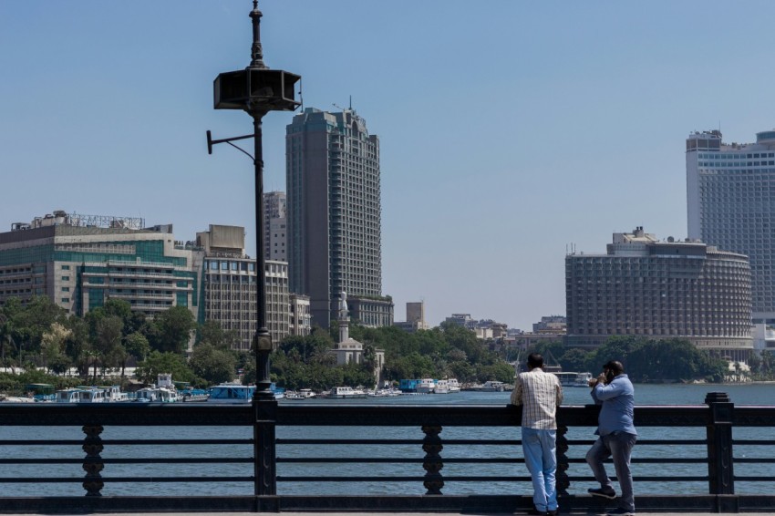 people standing on dock near city buildings during daytime v