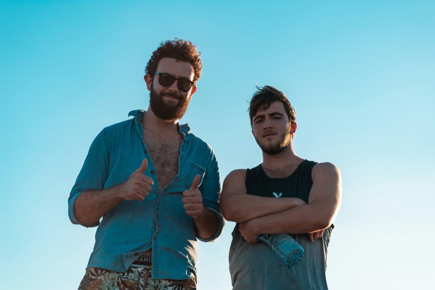 man in black tank top beside woman in blue denim jacket