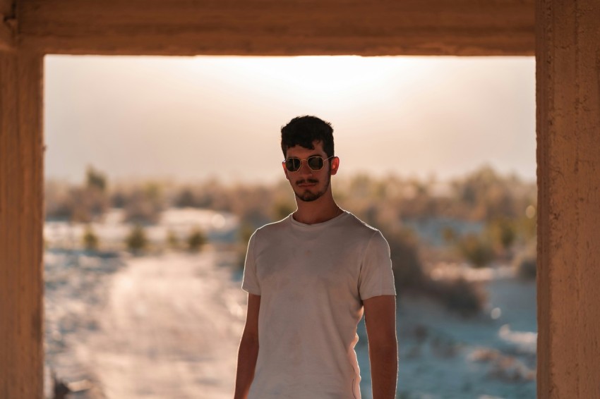 man in white crew neck t shirt wearing black sunglasses