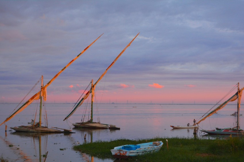 a group of sailboats floating on top of a body of water