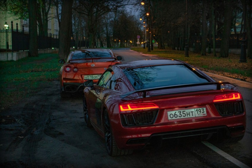 a couple of red sports cars parked next to each other