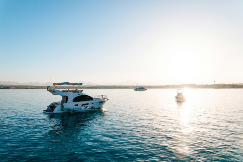 a white boat floating on top of a large body of water