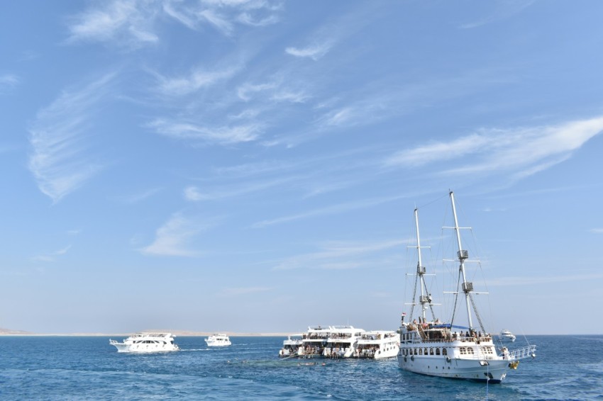 a group of boats floating on top of a body of water