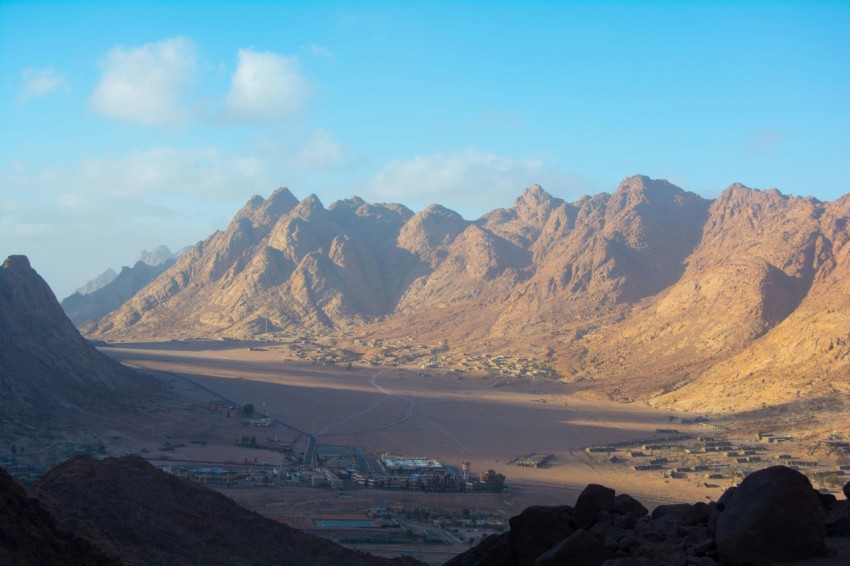 a view of a valley with mountains in the background