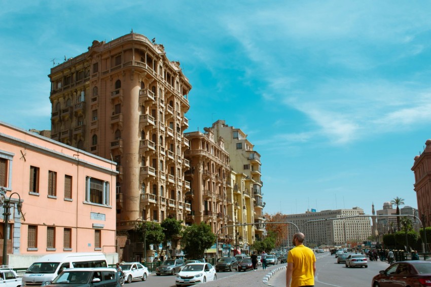 cars parked in front of brown concrete building during daytime
