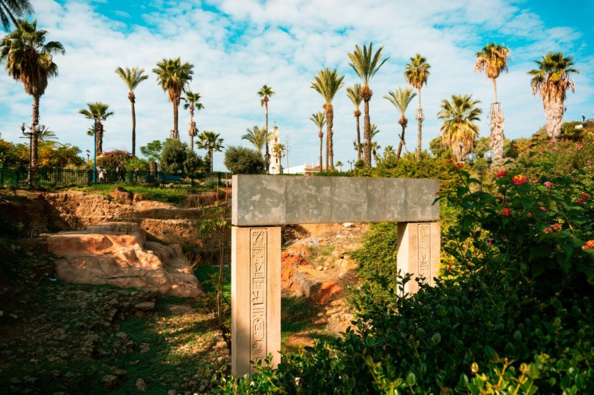 brown concrete cross on brown rock formation under blue sky during daytime