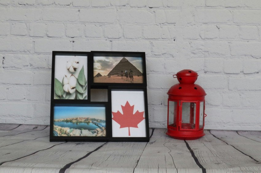 a red lantern sitting next to a white brick wall FmPNlk