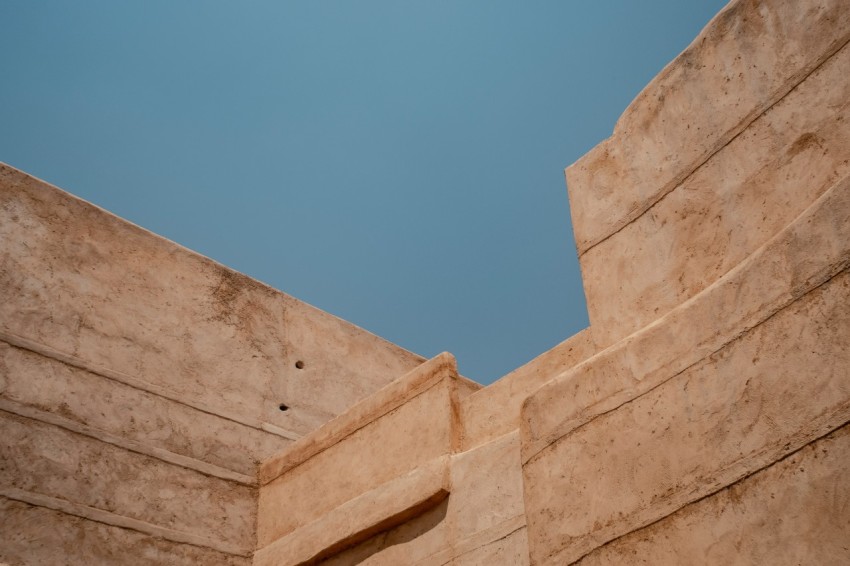 beige concrete building under blue sky during daytime