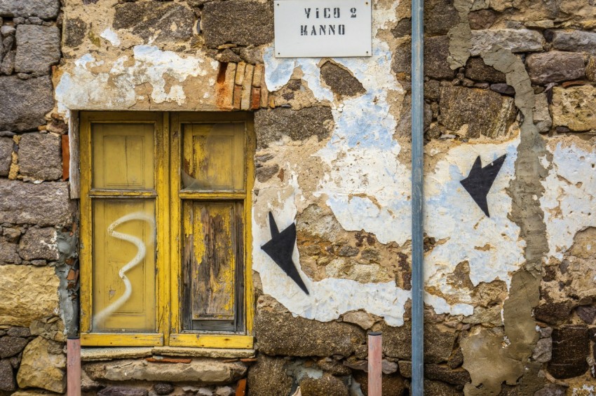 yellow wooden window panels beside brown concrete wall