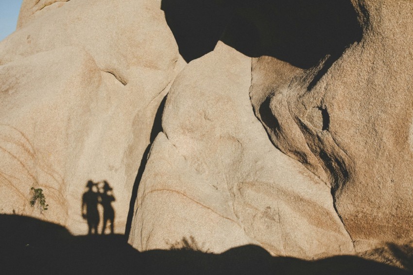 photo of human shadow on brown mountain during daytime