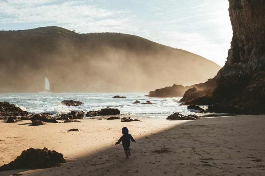 a child walking on a beach