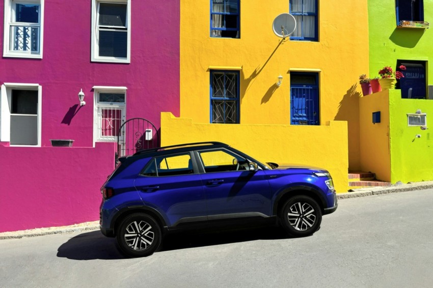 a car parked in front of a multi colored building