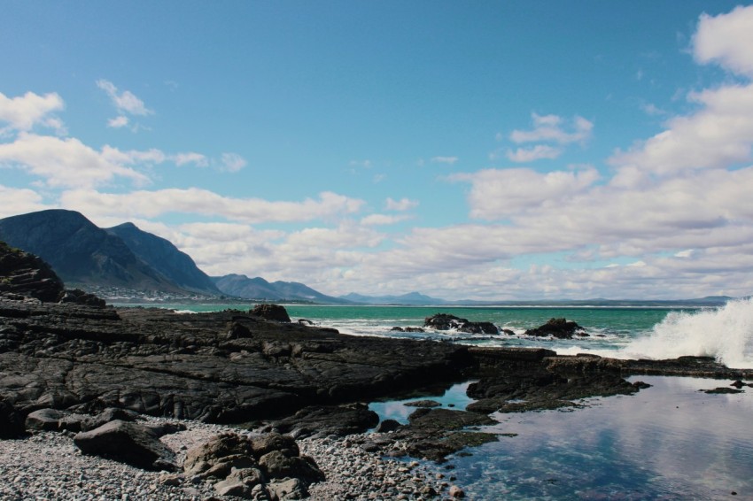 a body of water surrounded by rocks and mountains