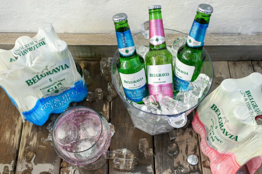 a glass bowl filled with ice and bottles of beer