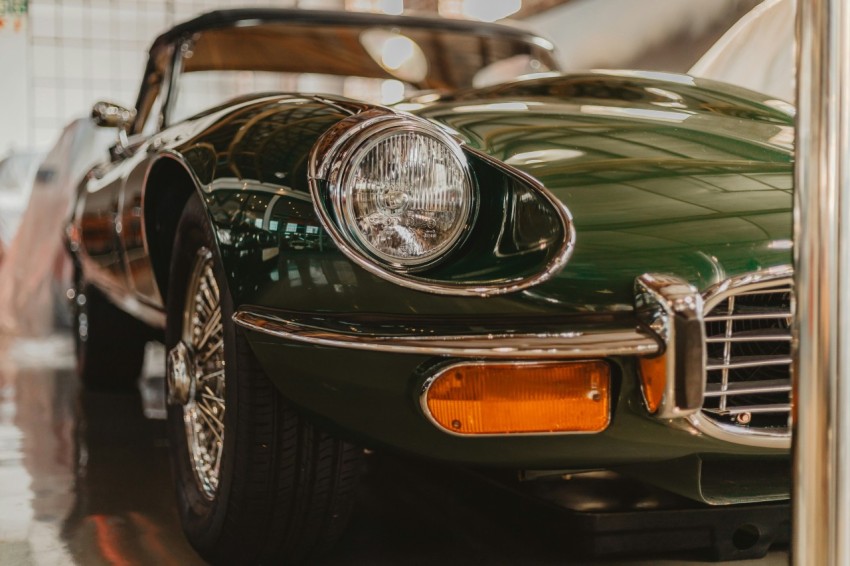 green porsche 911 parked in front of white car