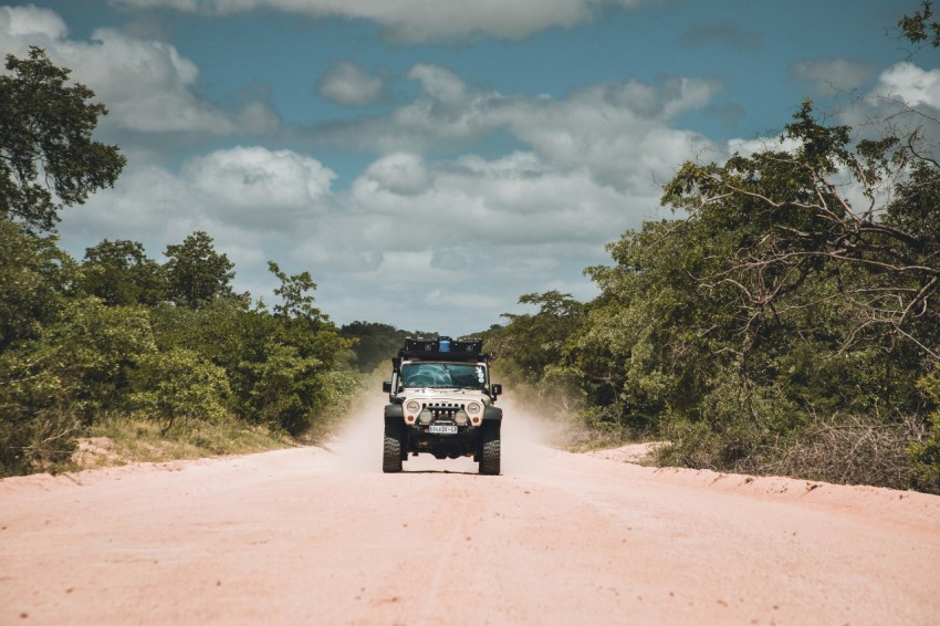 black suv on brown dirt road during daytime