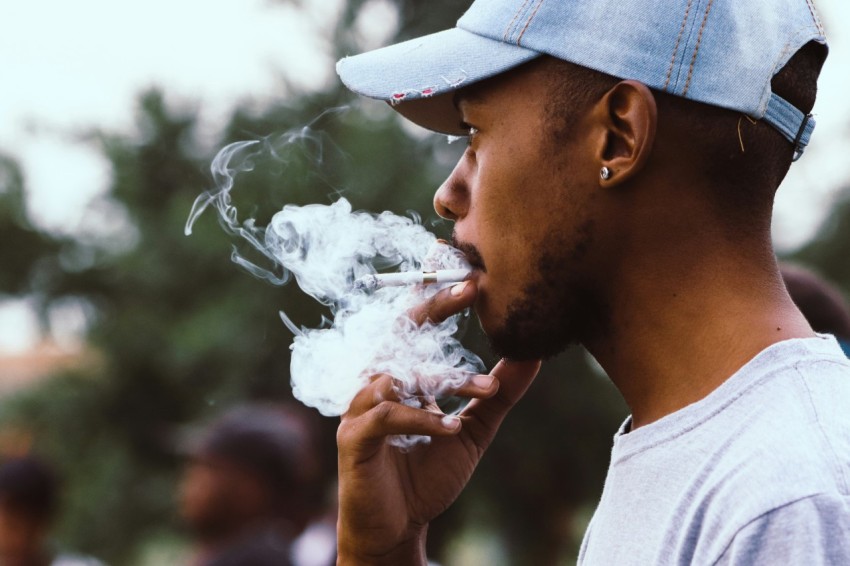 man smoking with blue denim cap 344vPA4O