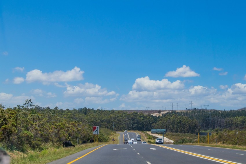 gray car on road under blue sky during daytime