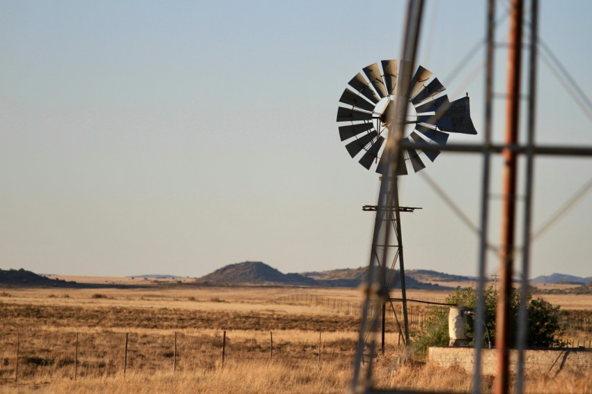 black windmill on brown field ocvXOq