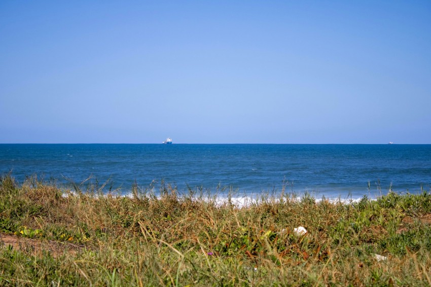 a boat out in the ocean on a sunny day