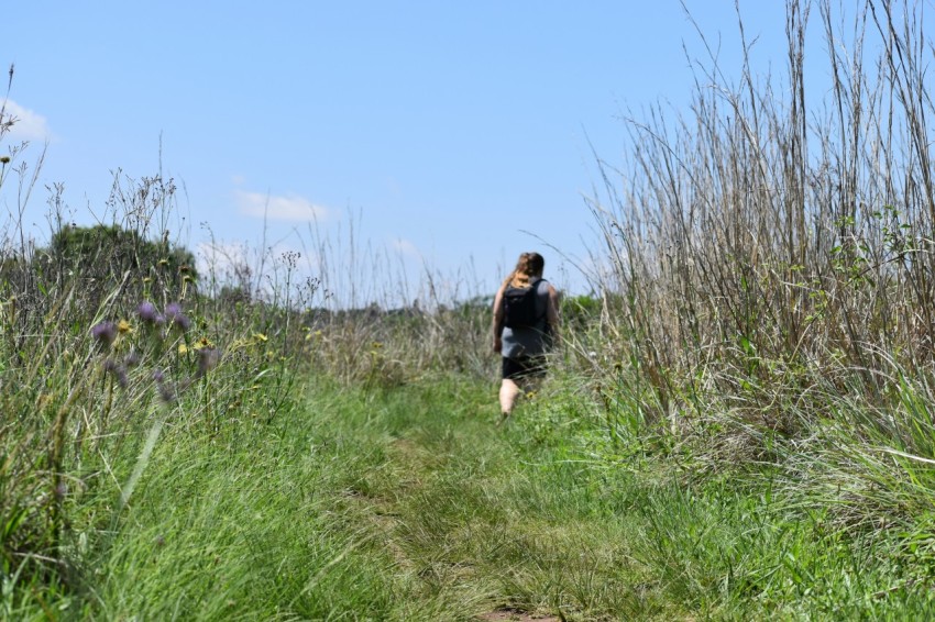 woman in black shirt standing on green grass field during daytime